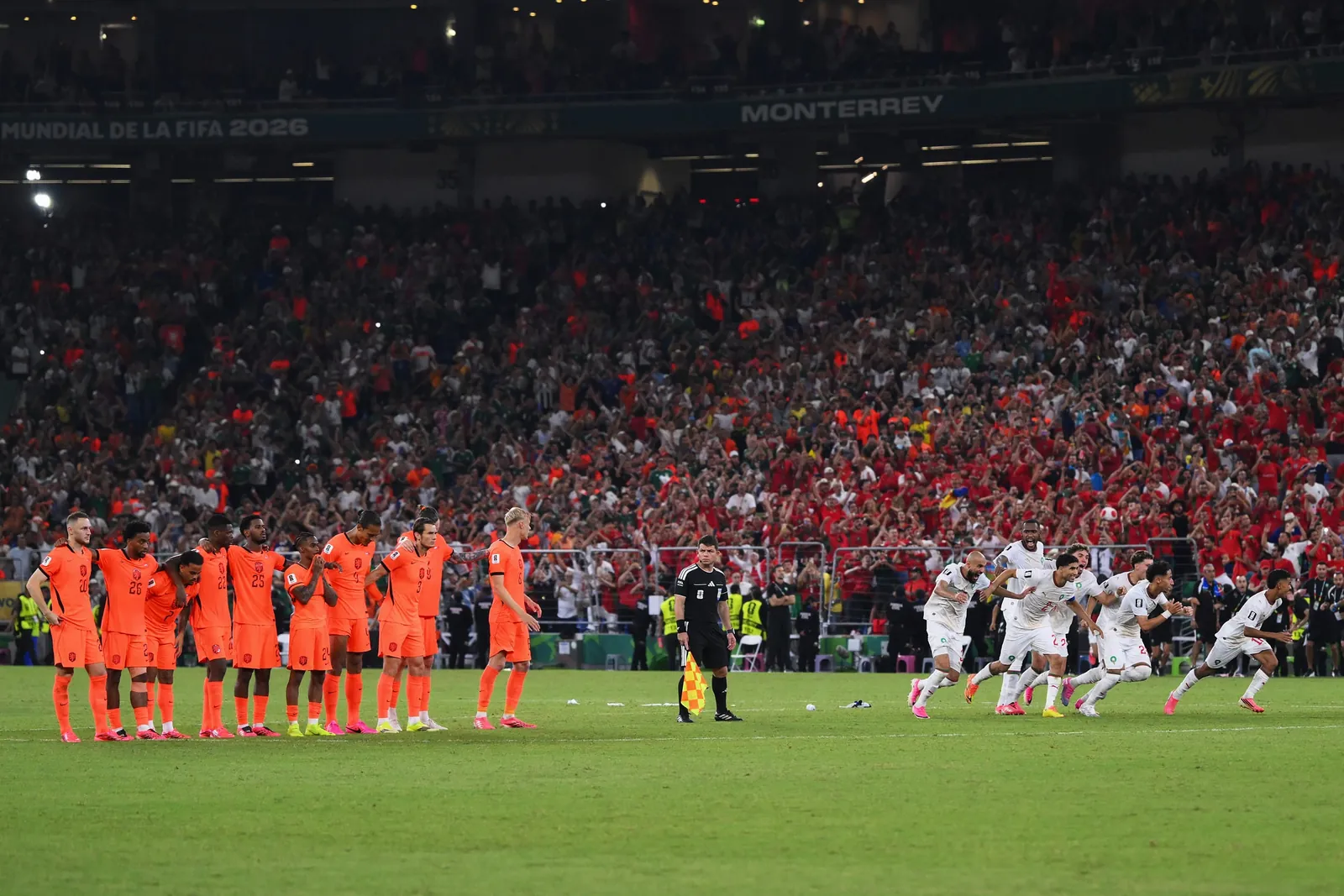 Players of Morocco dash as Ismael Saibari #11 of Morocco scores the team's fifth and winning penalty during the Netherlands v Morocco match.