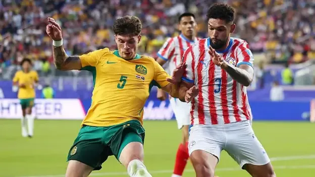 Jordan Bos of Australia and Omar Alderete battle for possession