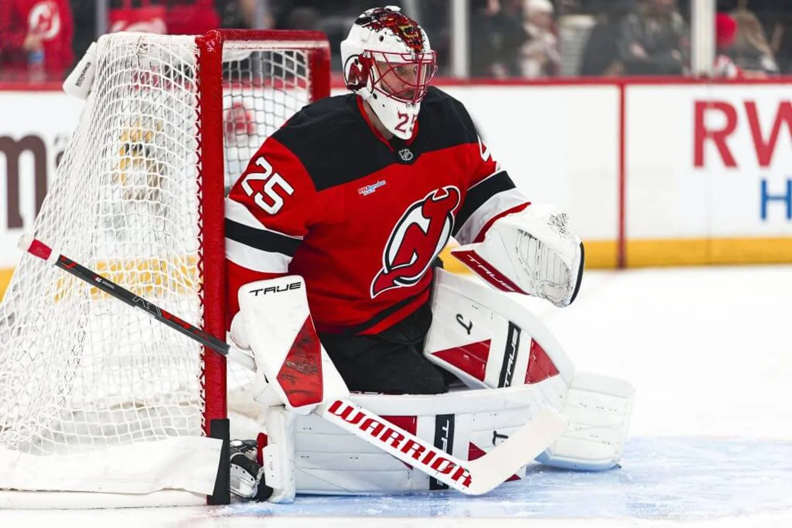 Wearing red and white Devils gear, Jacob Markstrom warms up before a March 2026 regular-season game.