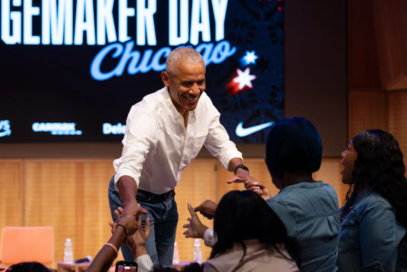 Former President Barack Obama surprises a group of ninth grade girls Friday during the WNBA Changemaker Day at the Obama Presidential Center in Jackson Park on the South Side.