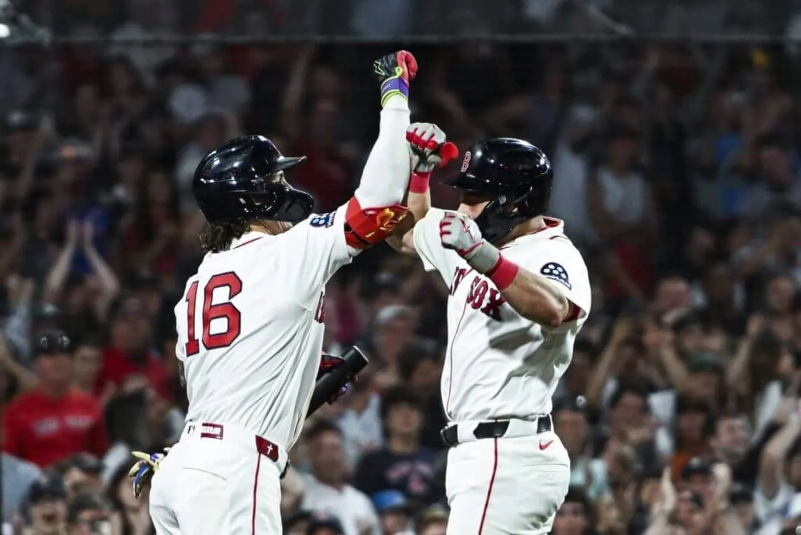 Boston's Jarren Duran greets Caleb Durbin at home plate after hitting a solo home run to take the lead in the eighth inning against Baltimore on Monday.
